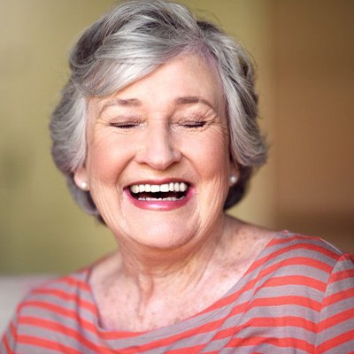 Woman smiling brightly in her own home