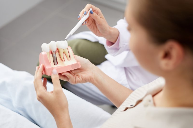 woman meeting with dentist for dental implant consultation